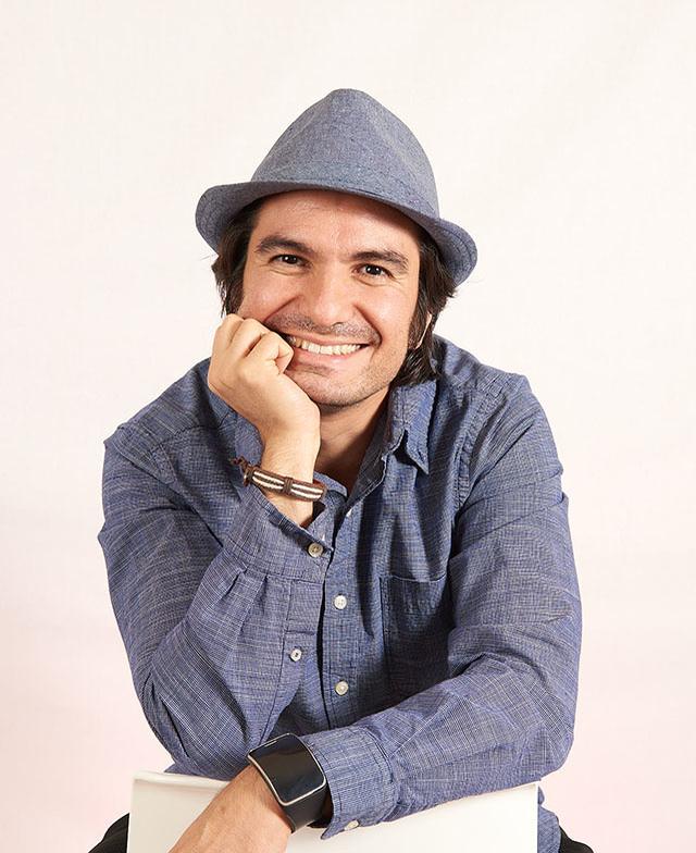 Afshin, the photographer behind Mezzonome, smiling, chin resting on one hand